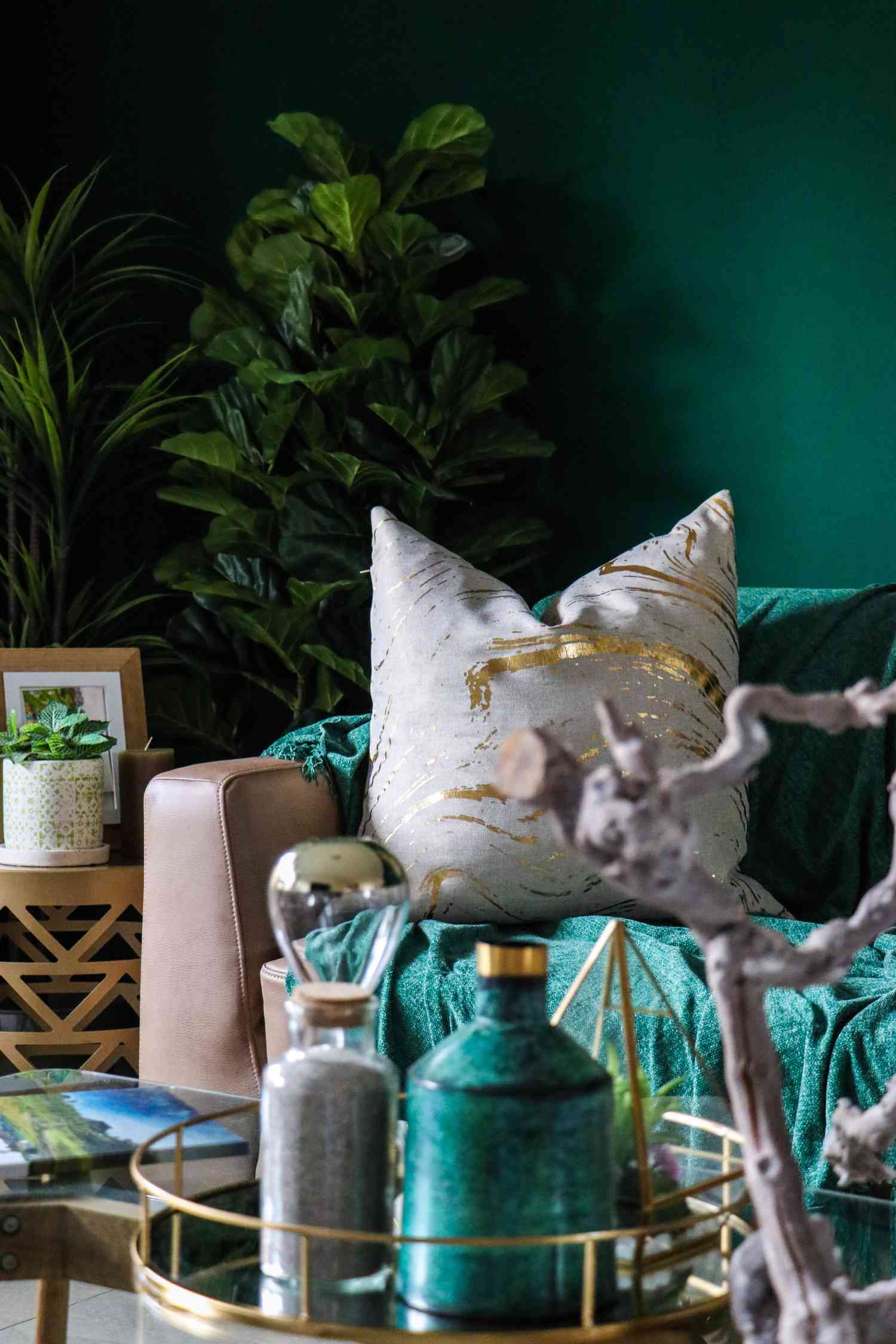 green and teal toned room with lush green plants