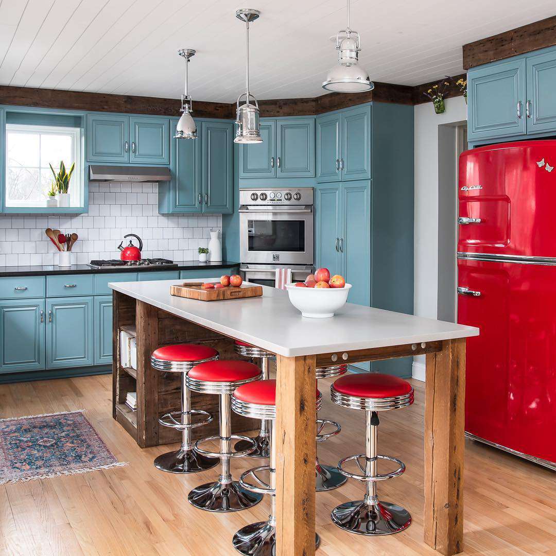 Teal kitchen with red appliances