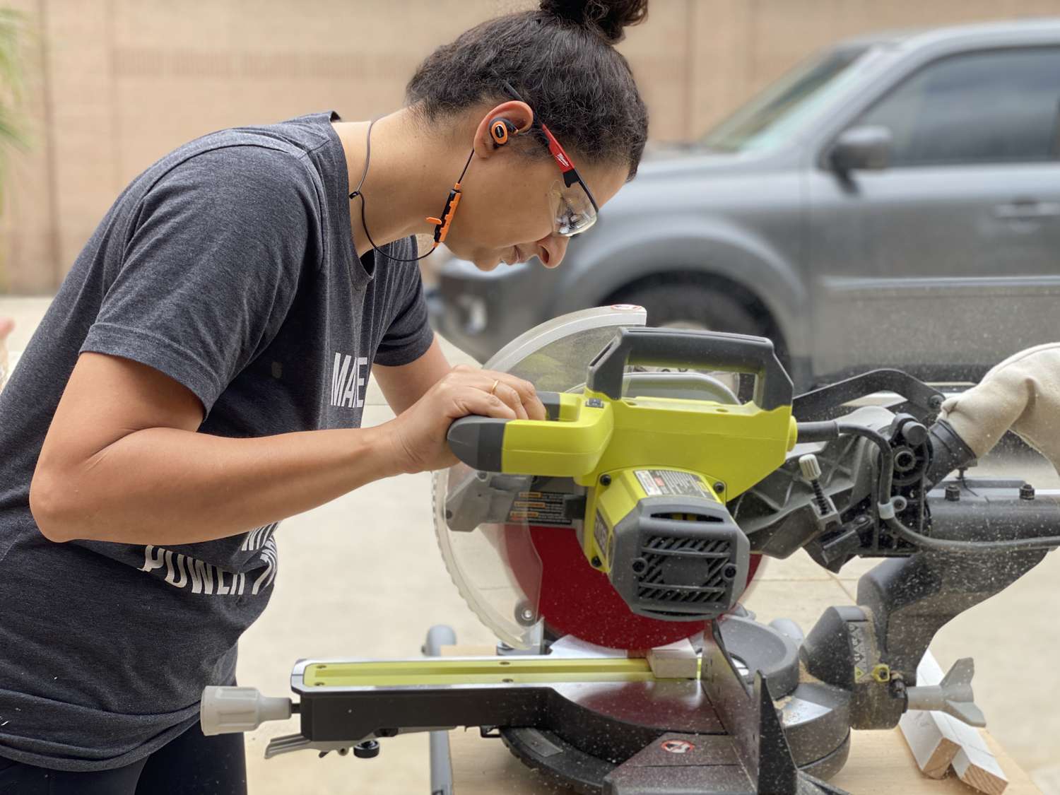 Anika Gandhi using a miter saw