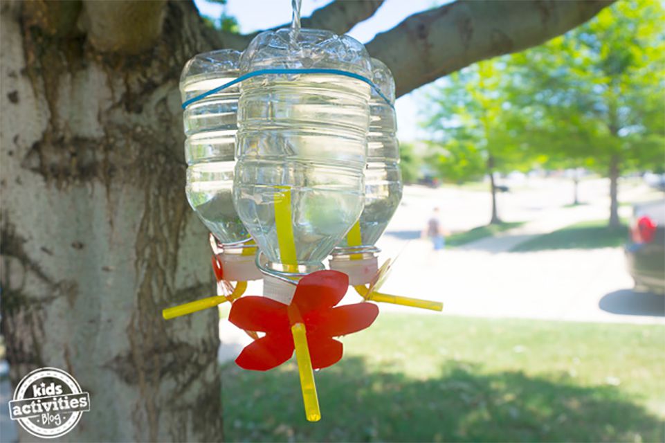 A hummingbird feeder made from a plastic bottle