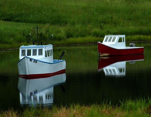 Bild von Minibooten im Teich mit Strandthema. Dekorative Boote sind nützlich in Strandgartenthemen.