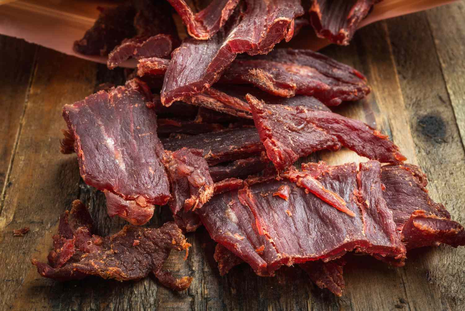 Large strips of jerky on a wooden surface