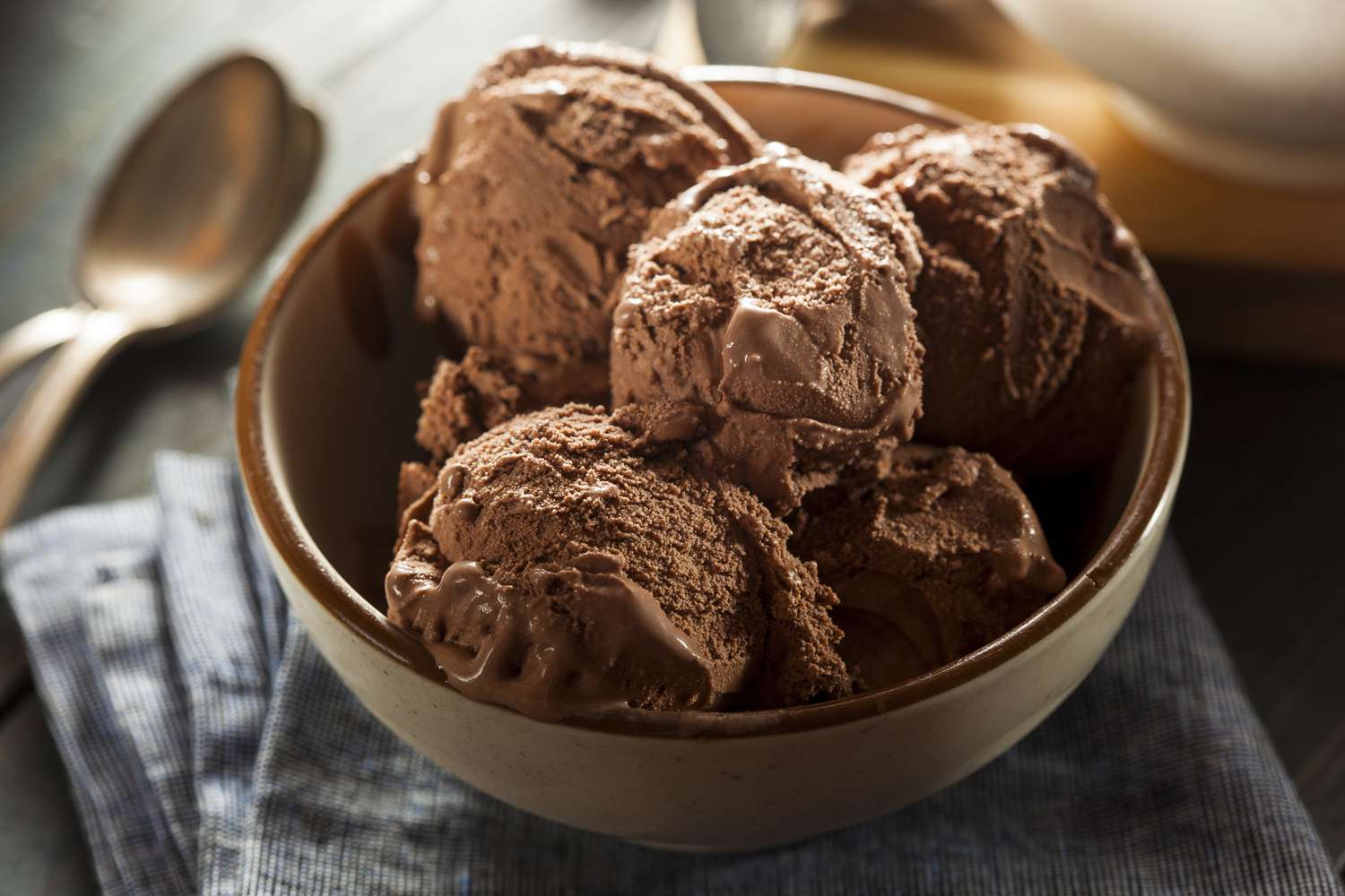 Scoops of chocolate ice cream in a brown bowl