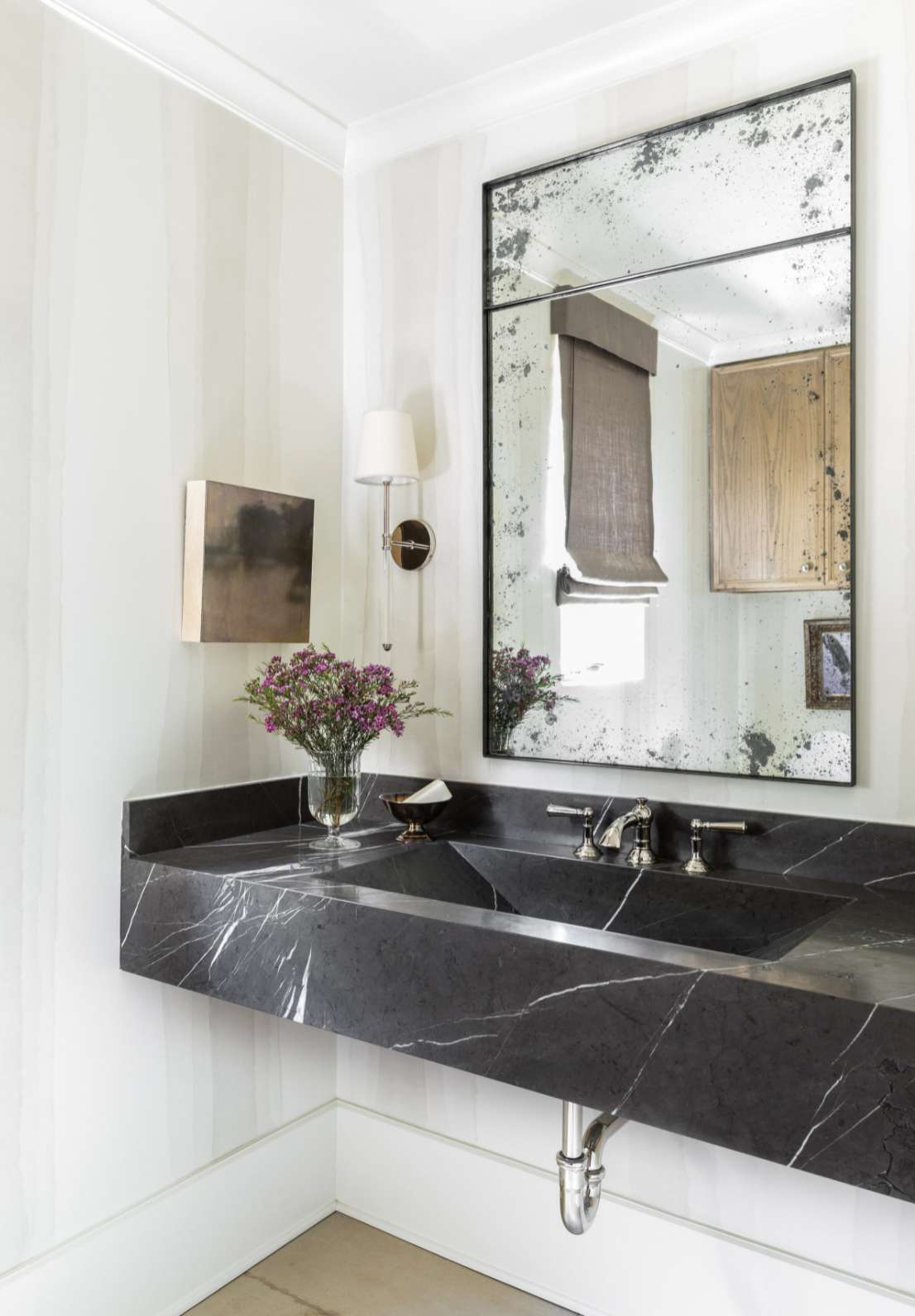 black marble vanity with white walls