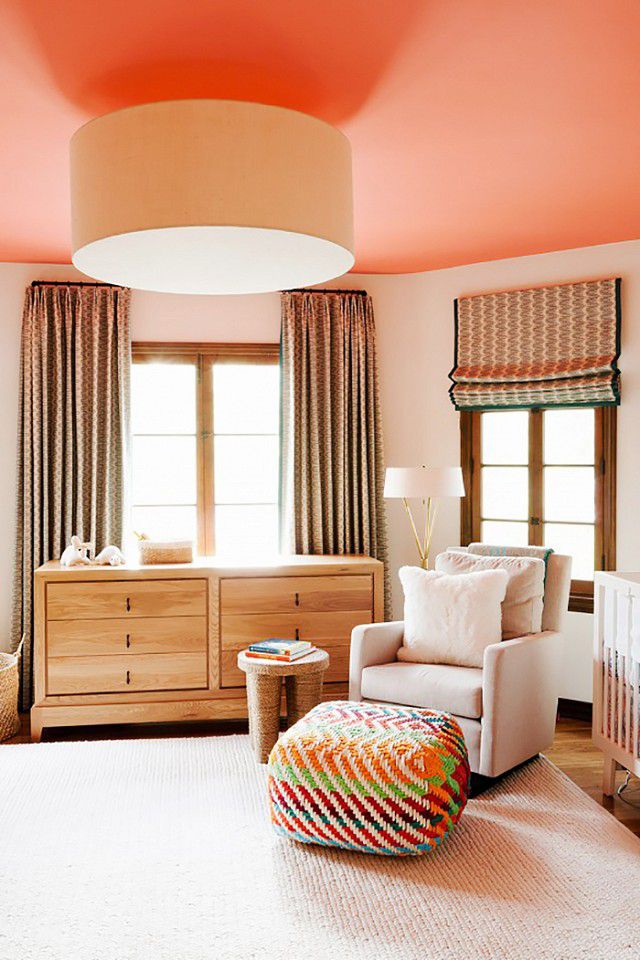 Neutral nursery with a painted, orange ceiling
