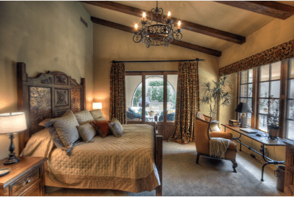 rustic wooden beams, plaster wall finishes, tuscan bedroom furniture, wrought iron chandeliers