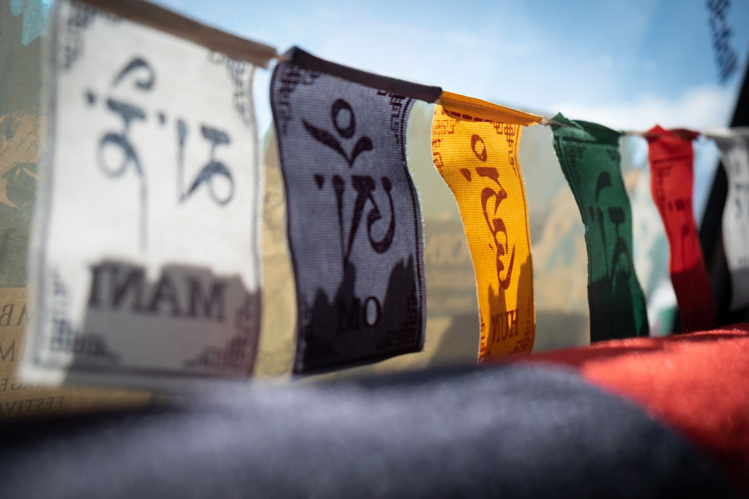 Close-up shot of small prayer flags with sunlight shining on them