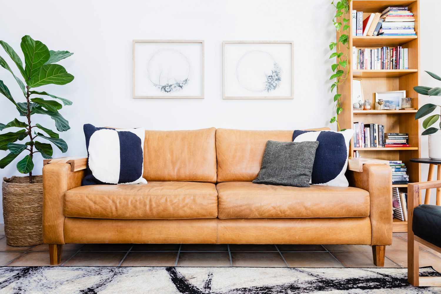 Tan leather sofa with throw pillows in a living room