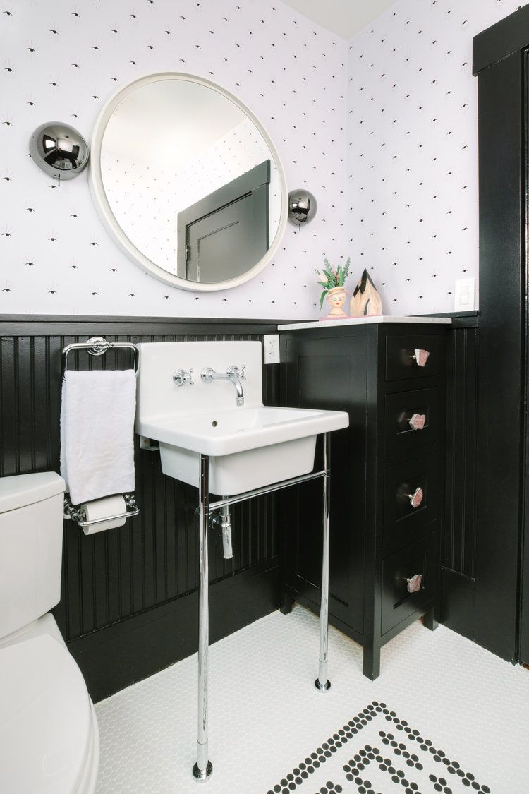 utility pedestal sink in black and white bathroom