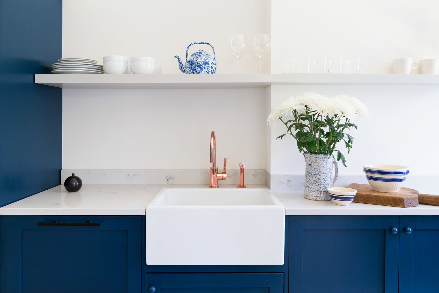 Armoires de cuisine bleu profond avec un évier de ferme blanc