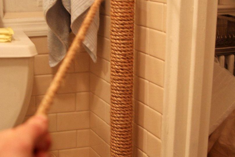 water pipe in bathroom hidden by wrapping it with rope