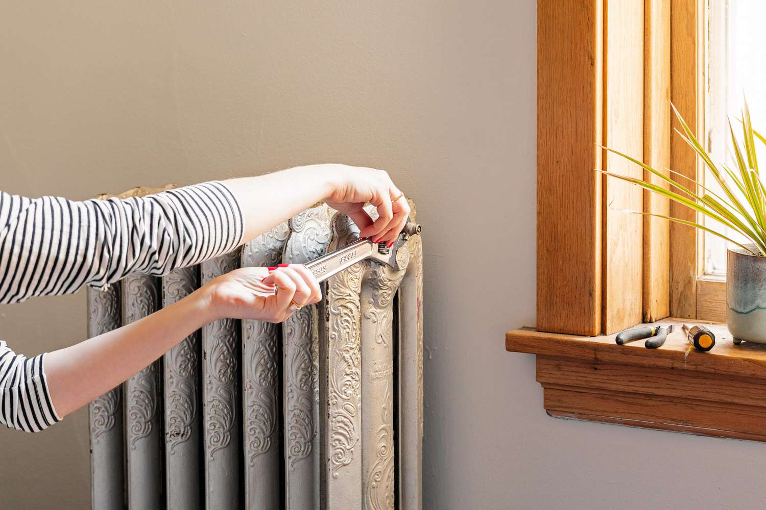 person performing radiator maintenance