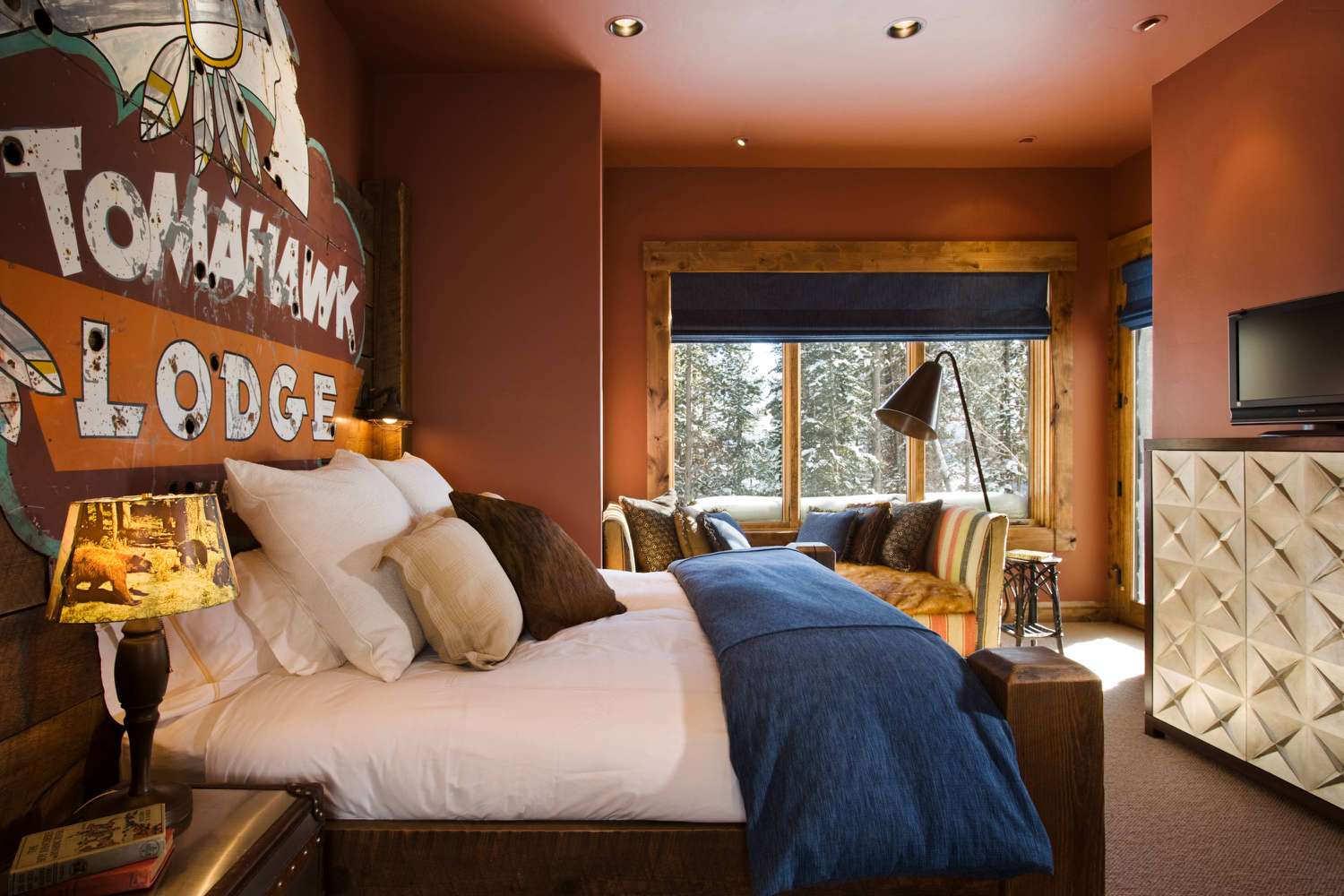 Campy rustic bedroom with vintage motel sign
