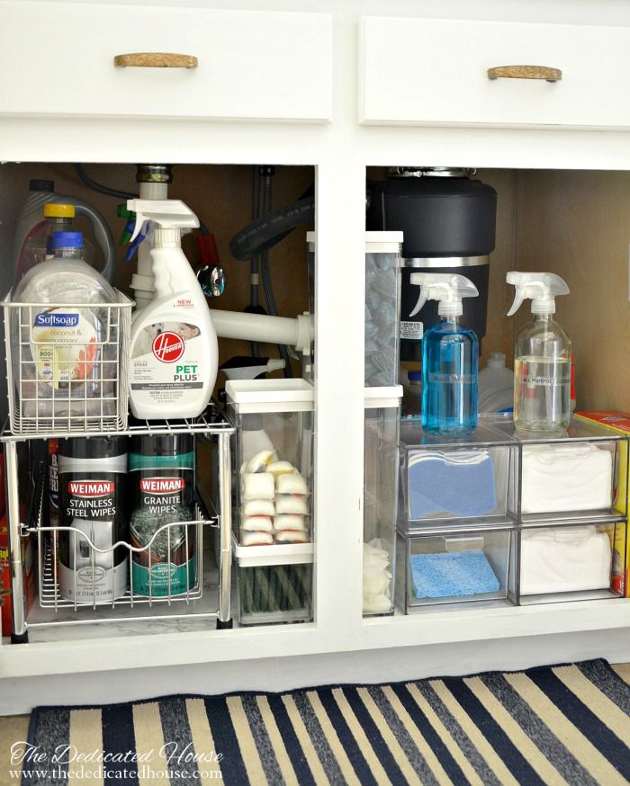 Organized under sink area with cleaning supplies.