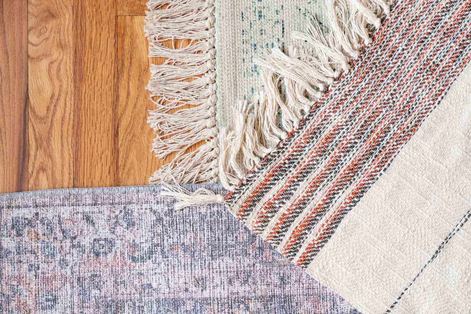 Hand-knotted and hand tufted rugs compared on wooden floor