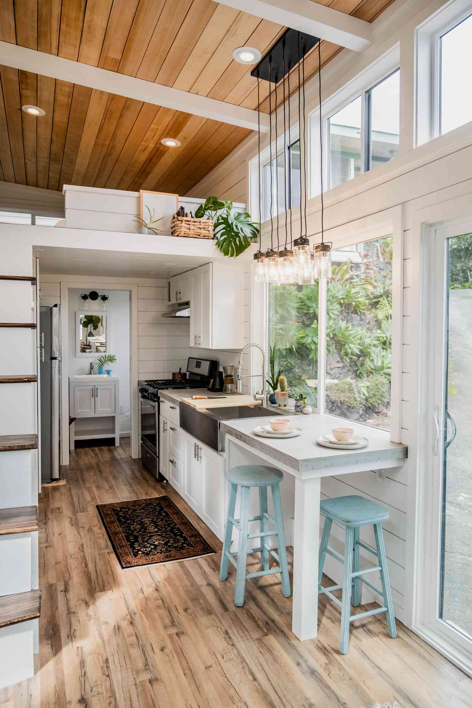 airy tiny home kitchen with white cabinets