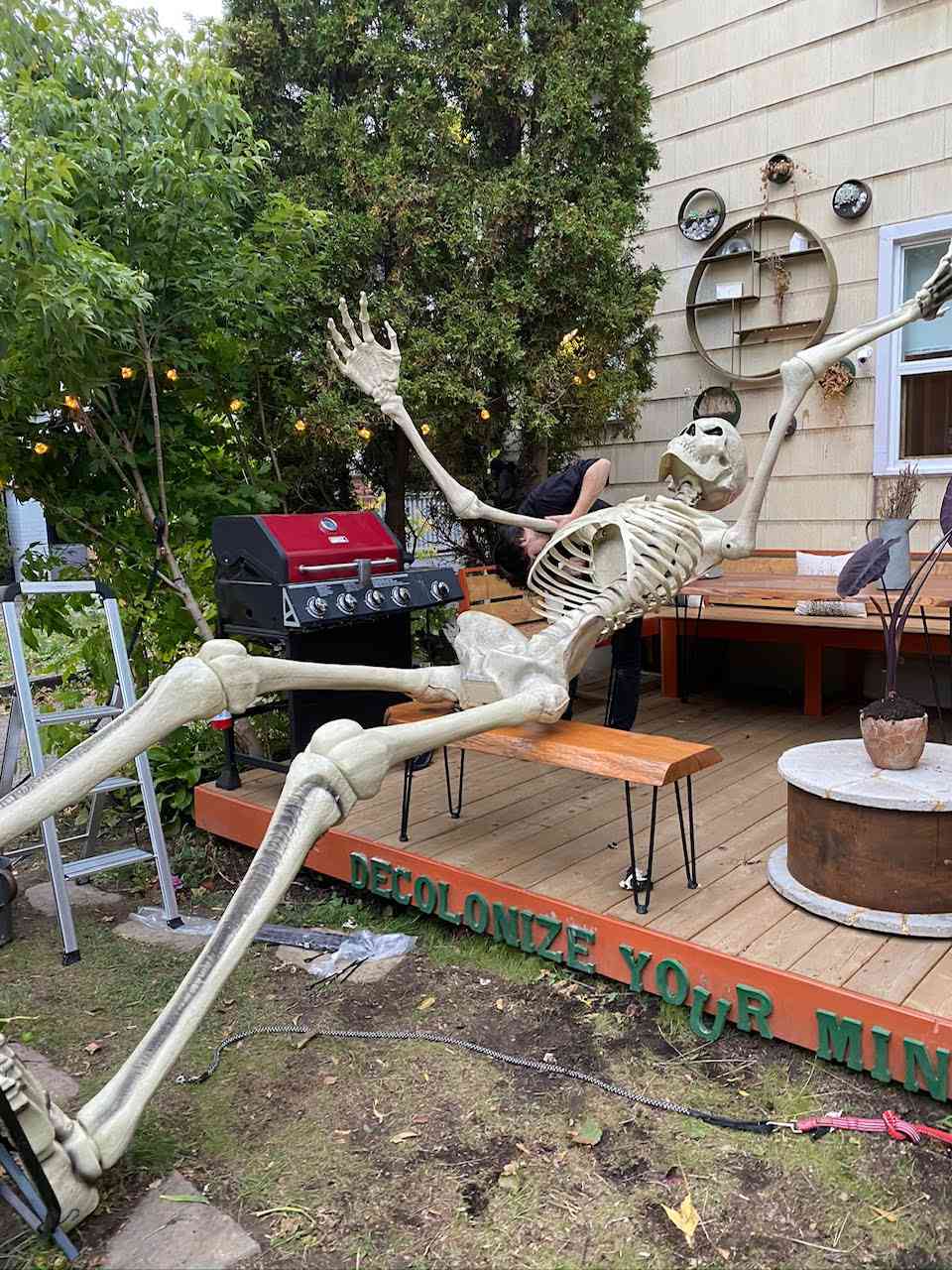 12-foot skeleton on bench