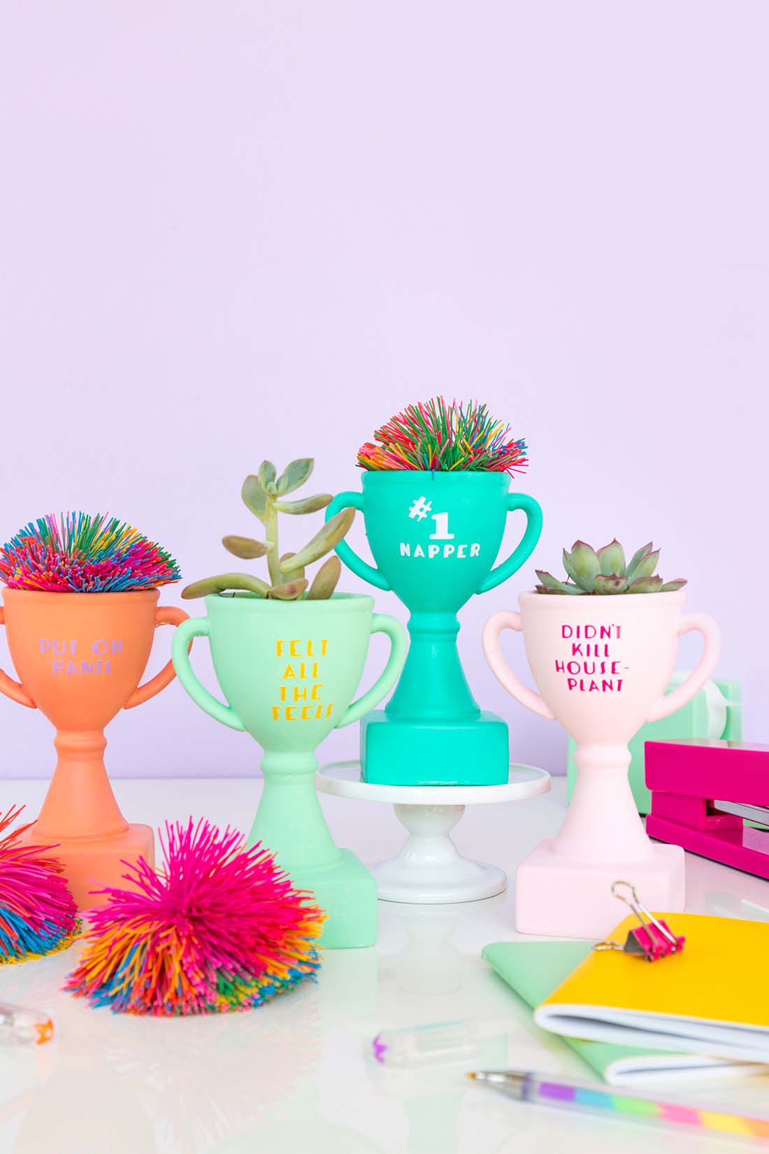 Colorful trophies with plants in them
