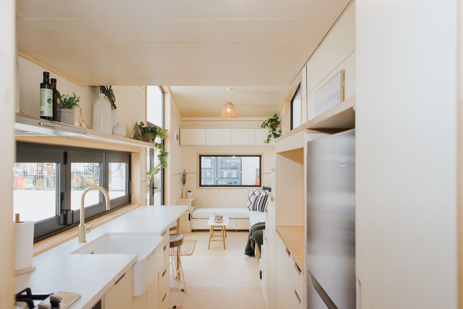 a tiny home kitchen with light wood and clean lines