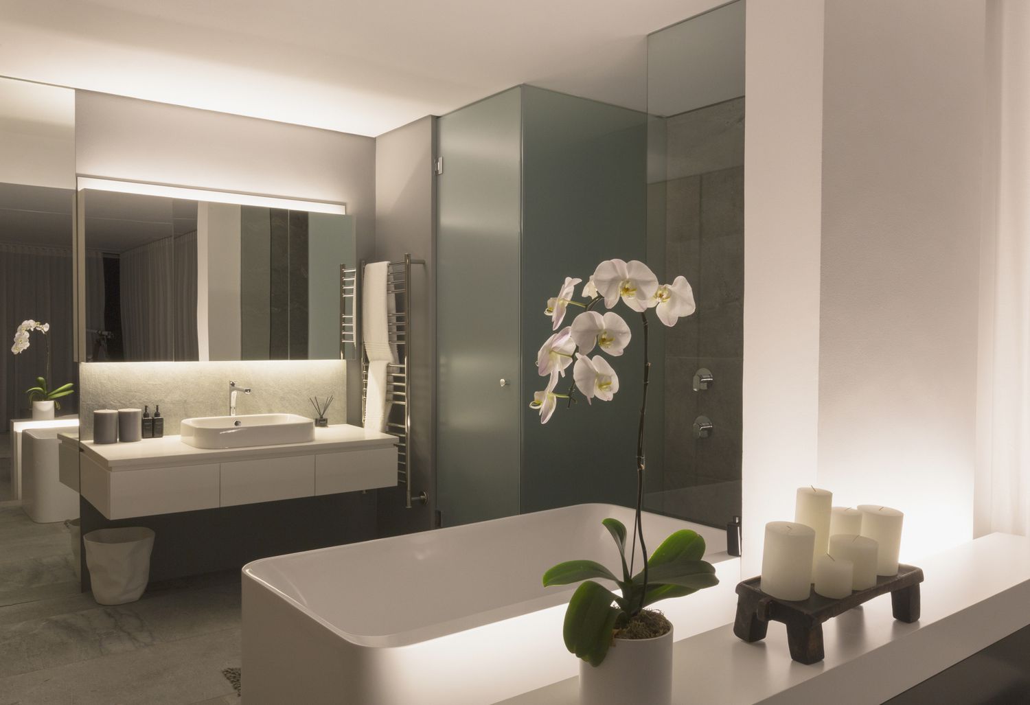 Illuminated modern, luxury home showcase bathroom