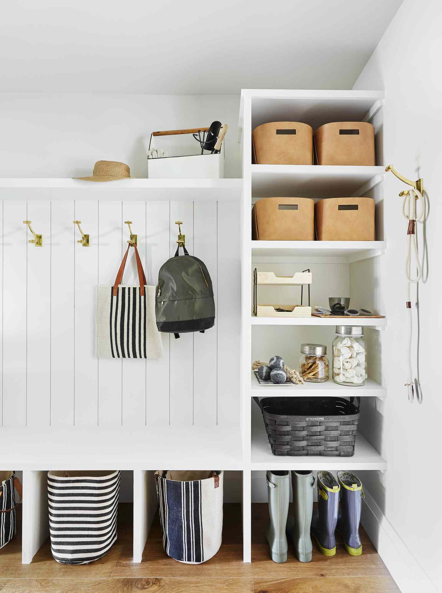 Leather storage cubes in white mudroom built-ins