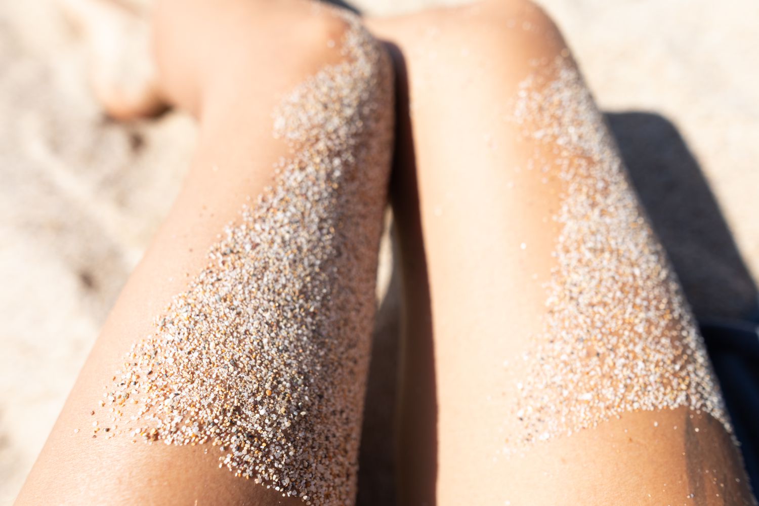 sand covered legs on beach