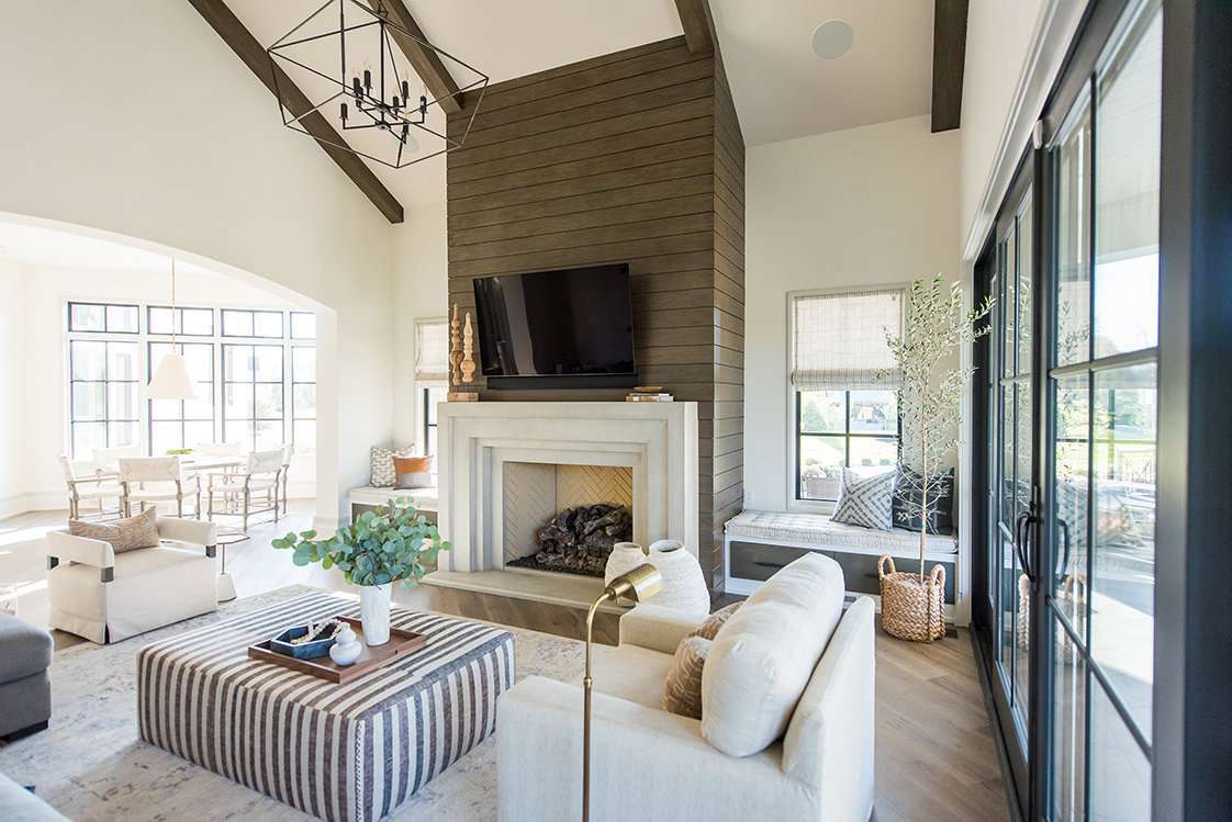 Large living room with vaulted ceilings and a statement fireplace.