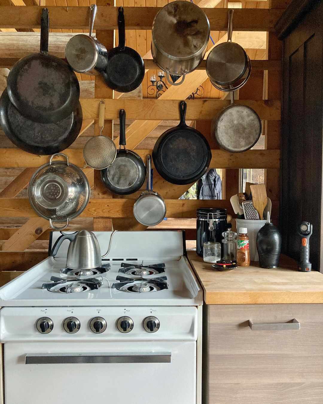 pans hanging on wooden wall