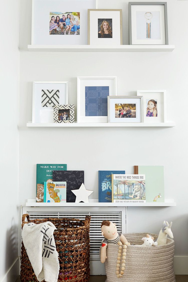White Photo Ledges With Varied Picture Frames And Books