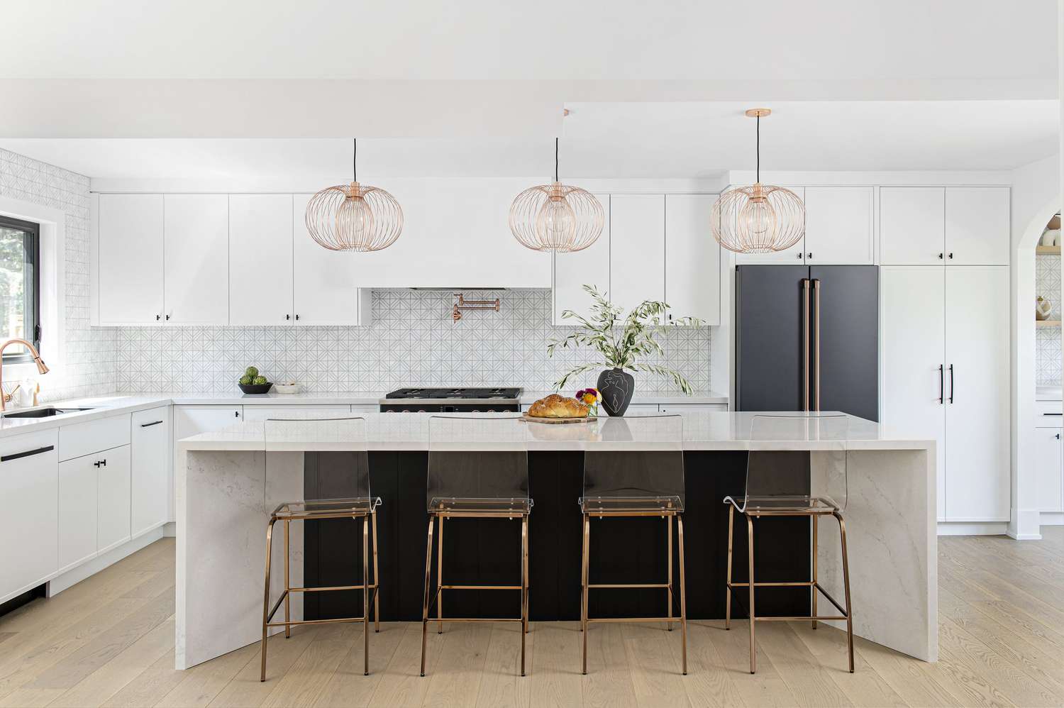 patterned tile backsplash with white cabinets