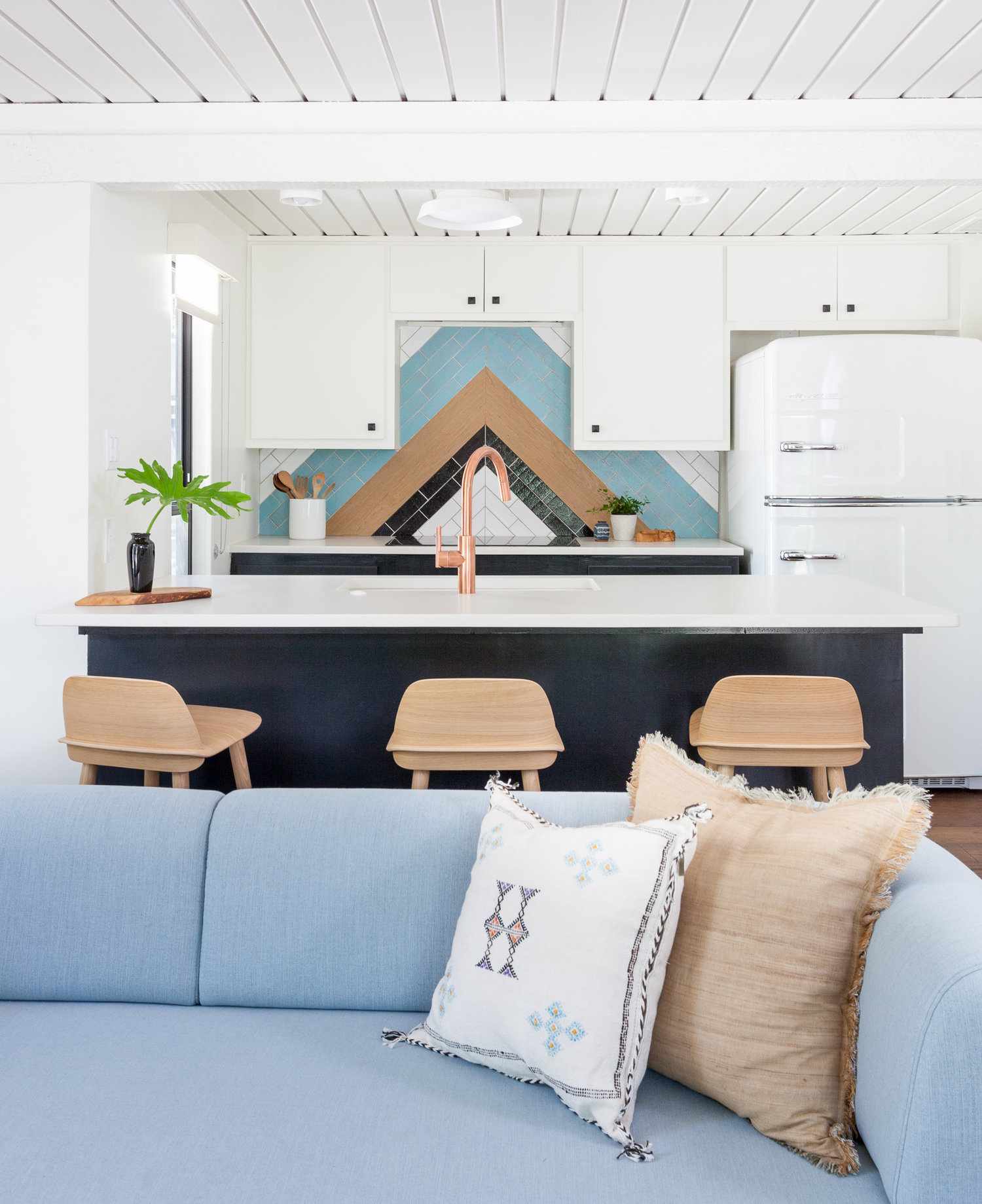 multicolored backsplash white cabinets