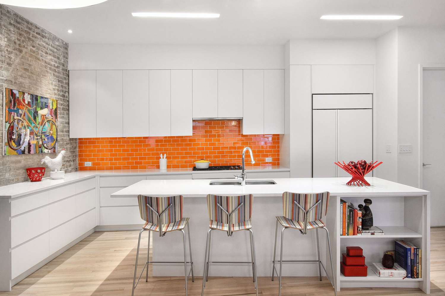 orange tile backsplash with white kitchen cabinets