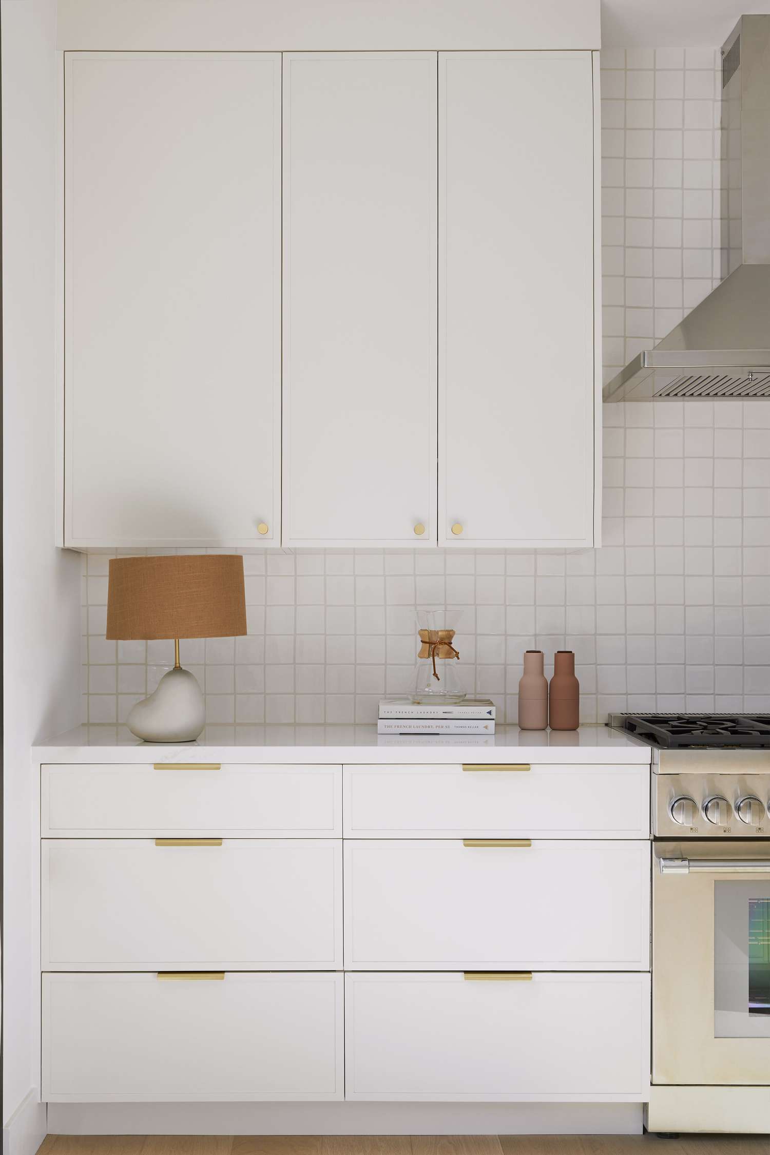 white square tile backsplash with white cabinets
