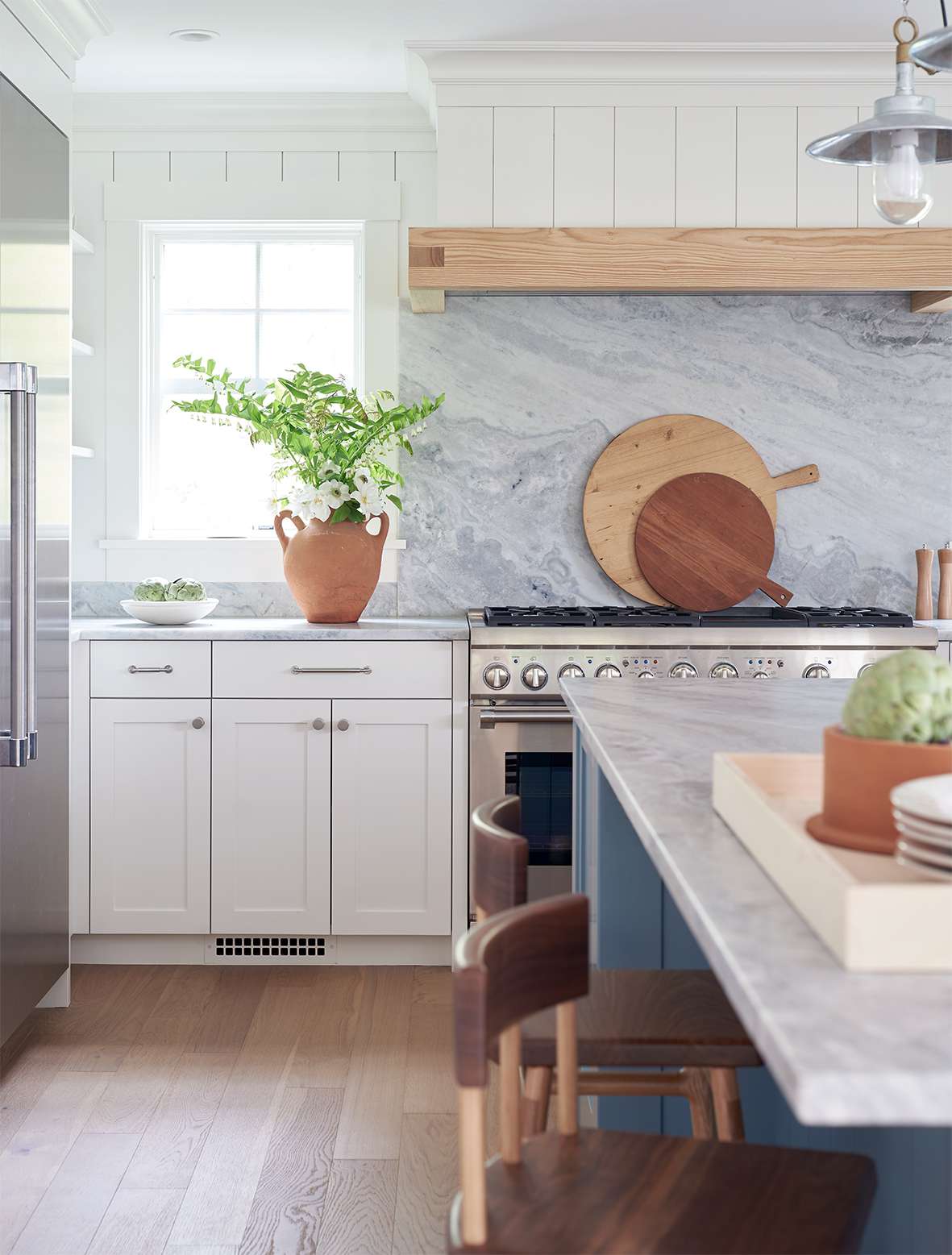 shiplap and stone backsplash with white cabinets