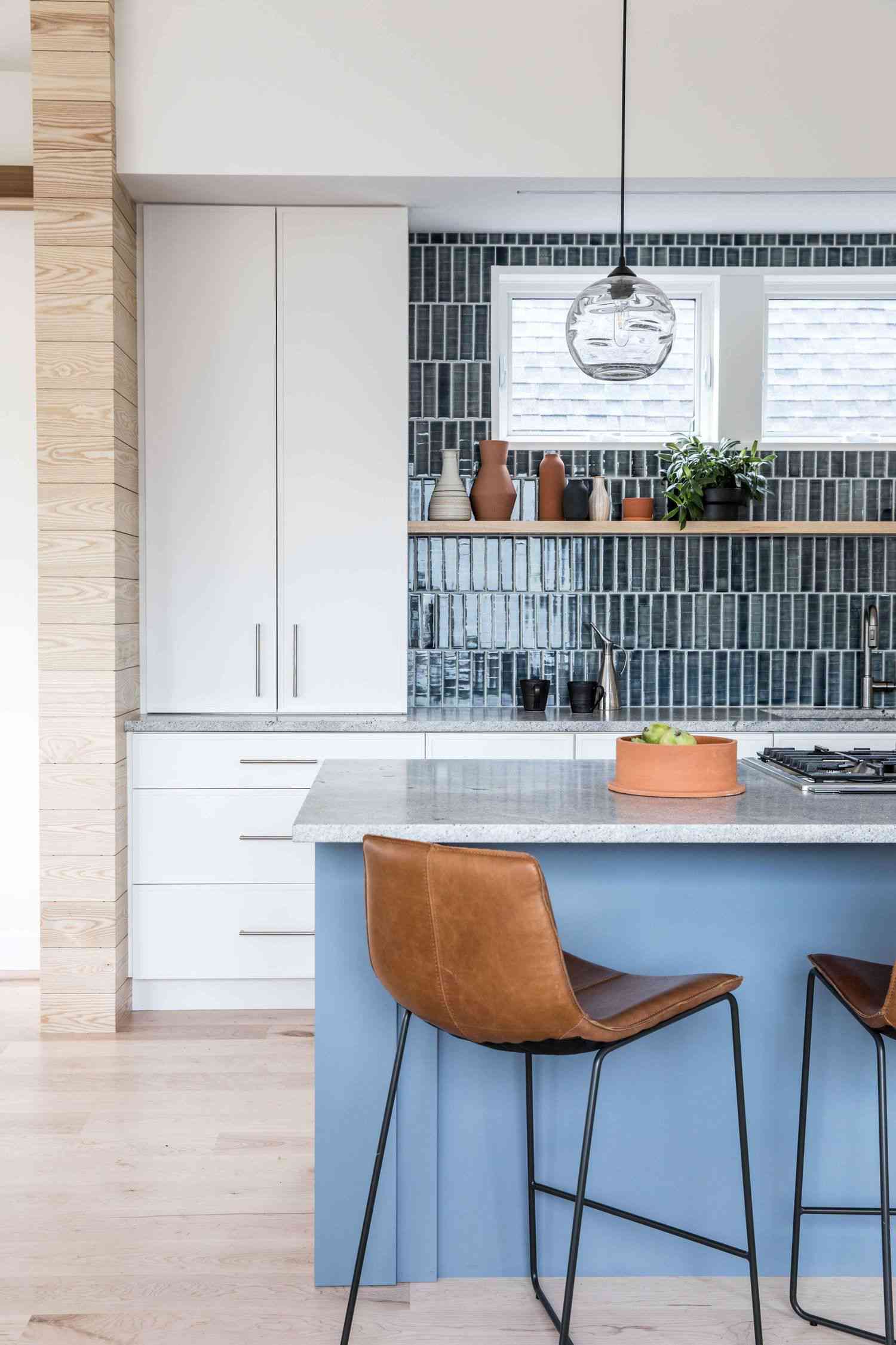 blue vertical tile backsplash with white cabinets