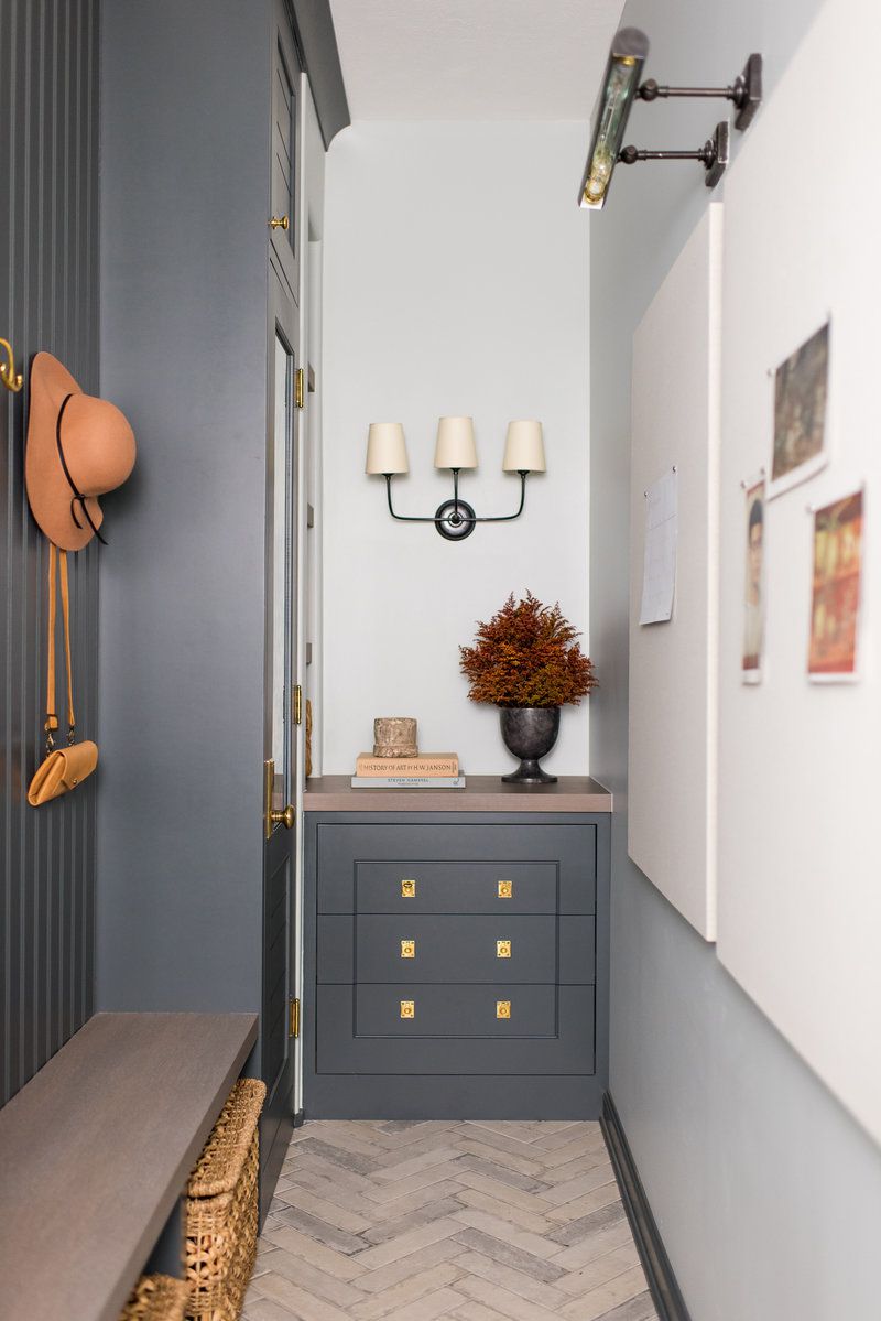 Entryway mudroom featuring picture frame lighting.