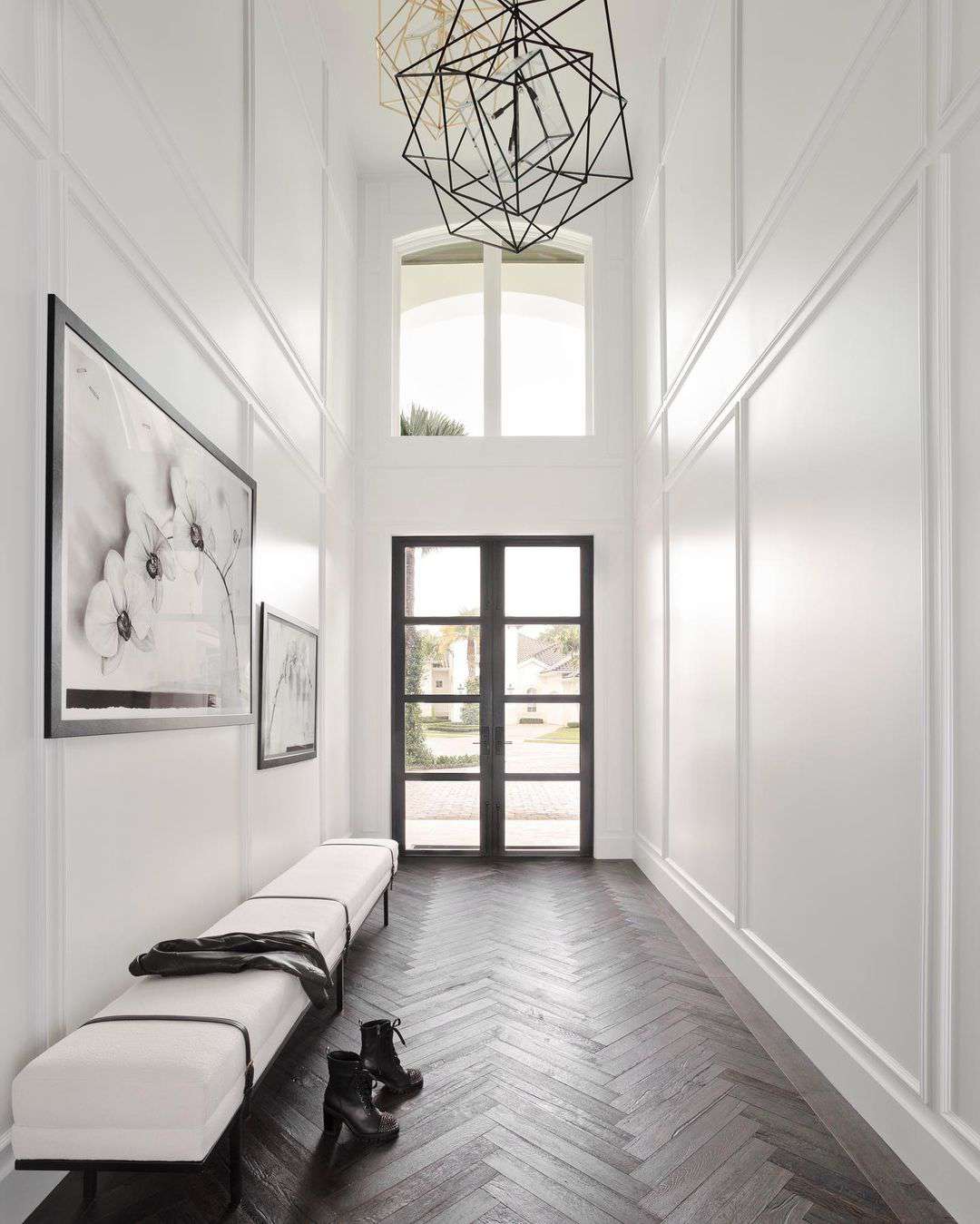 Large entryway with caged chandelier.