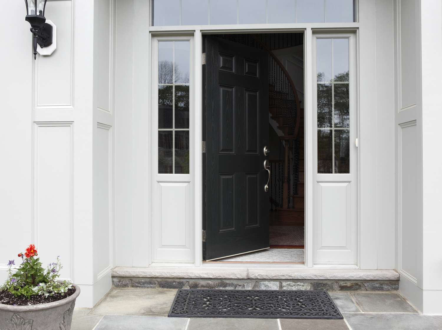 Front porch of house with front door open