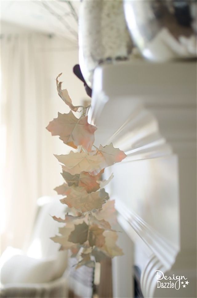 A white fall garland hanging on a mantle