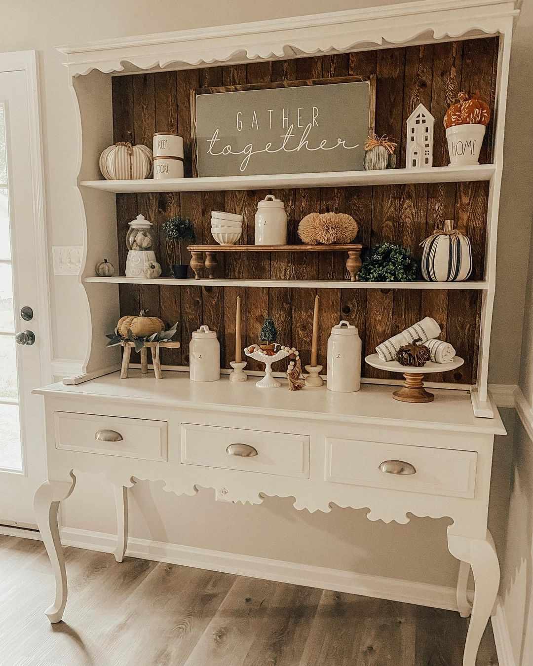 Fall decor displayed in a kitchen hutch