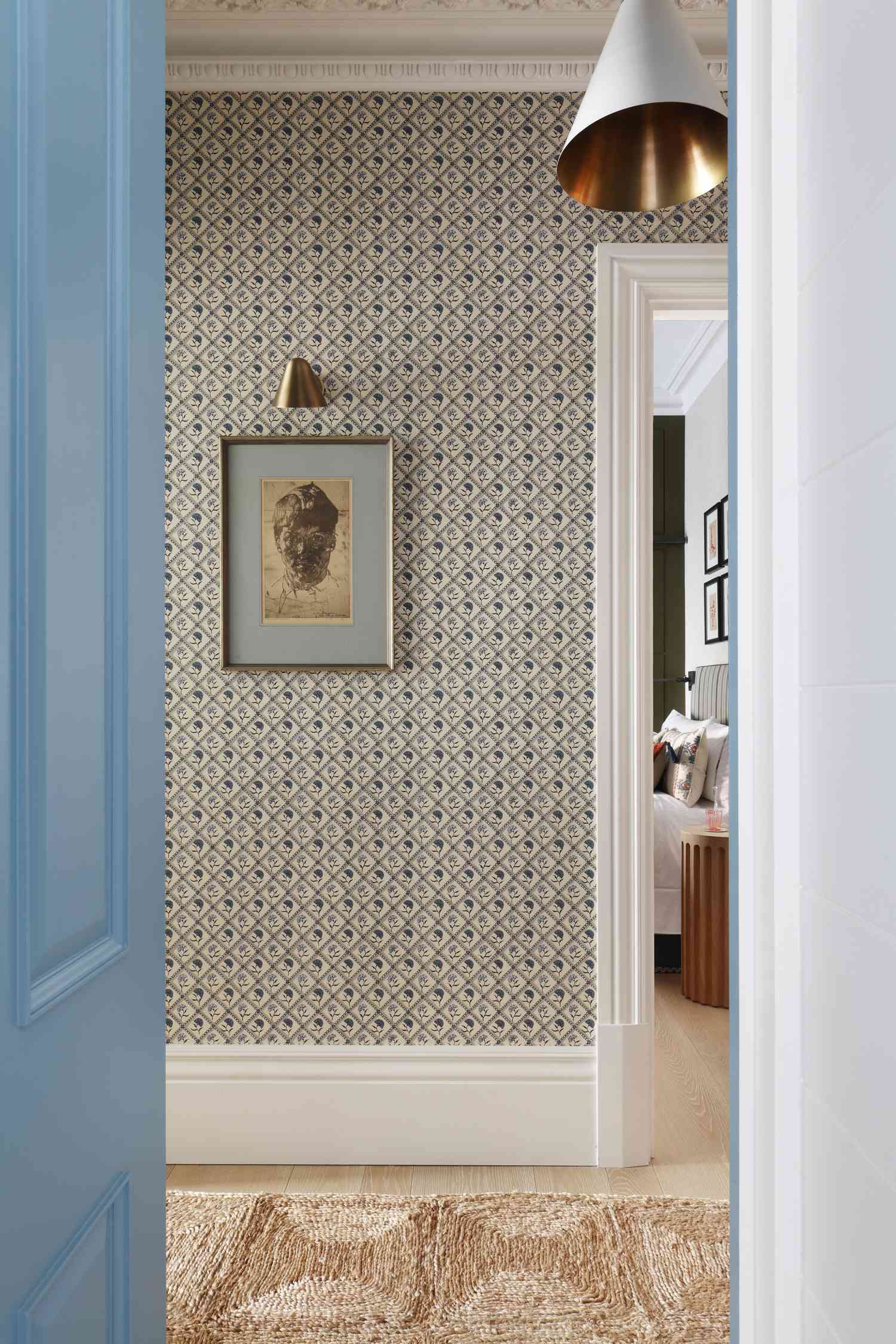 wallpapered hallway with art