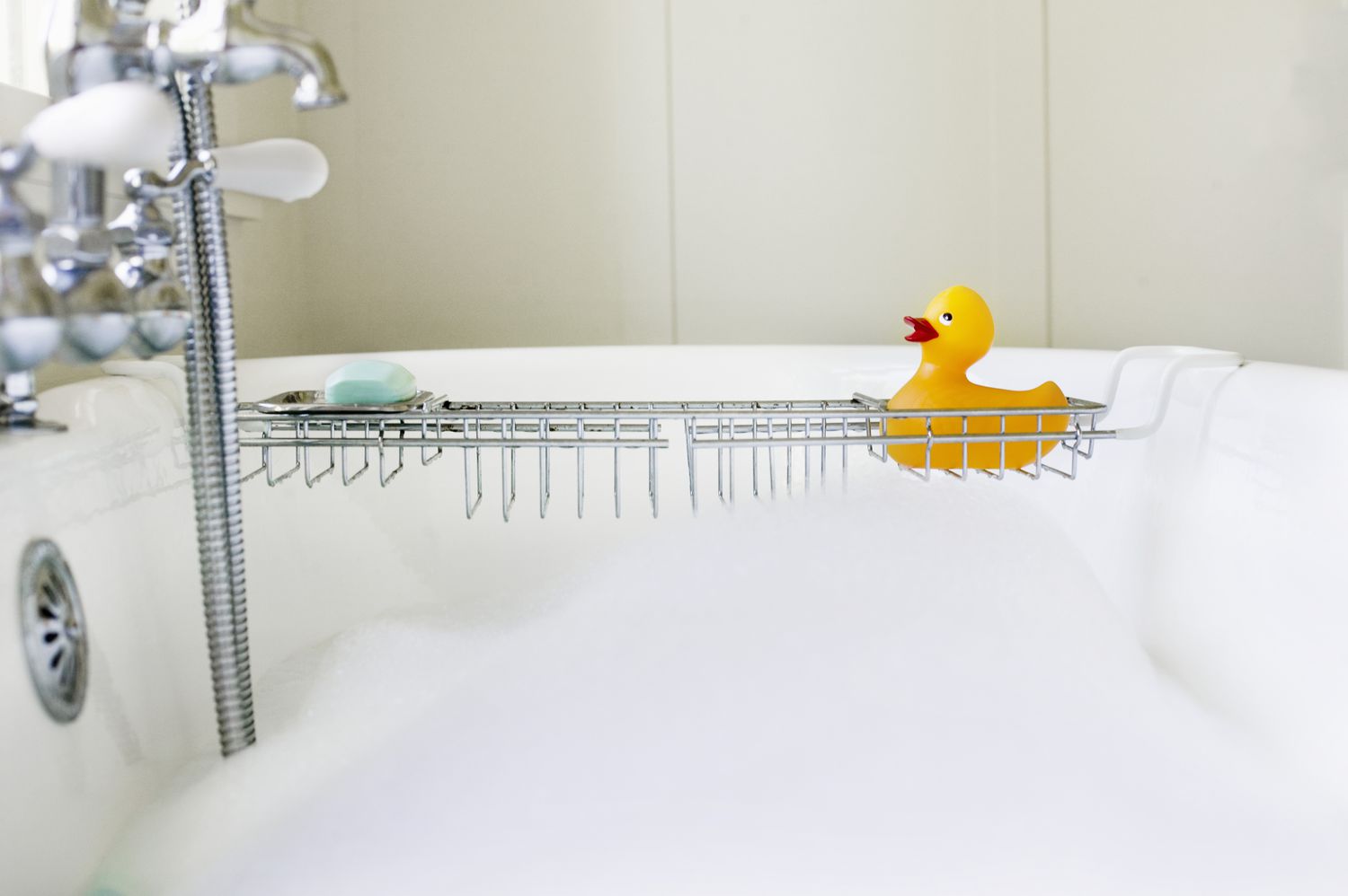 Rubber duck on rack over bathtub