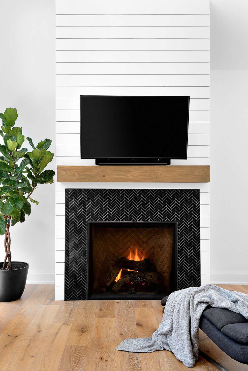 white shiplap fireplace with black tile