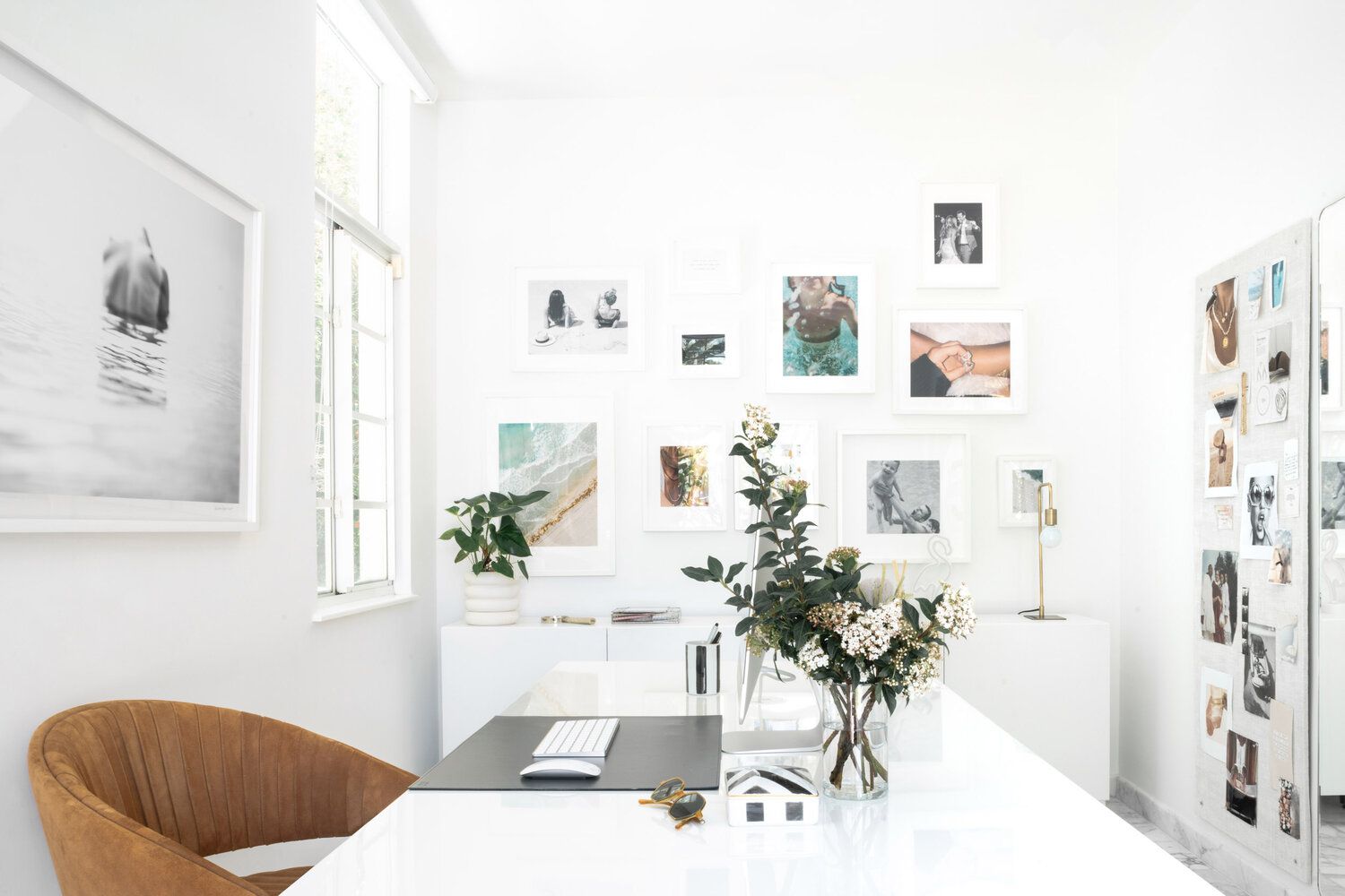 Bright office with a gallery wall accent wall.