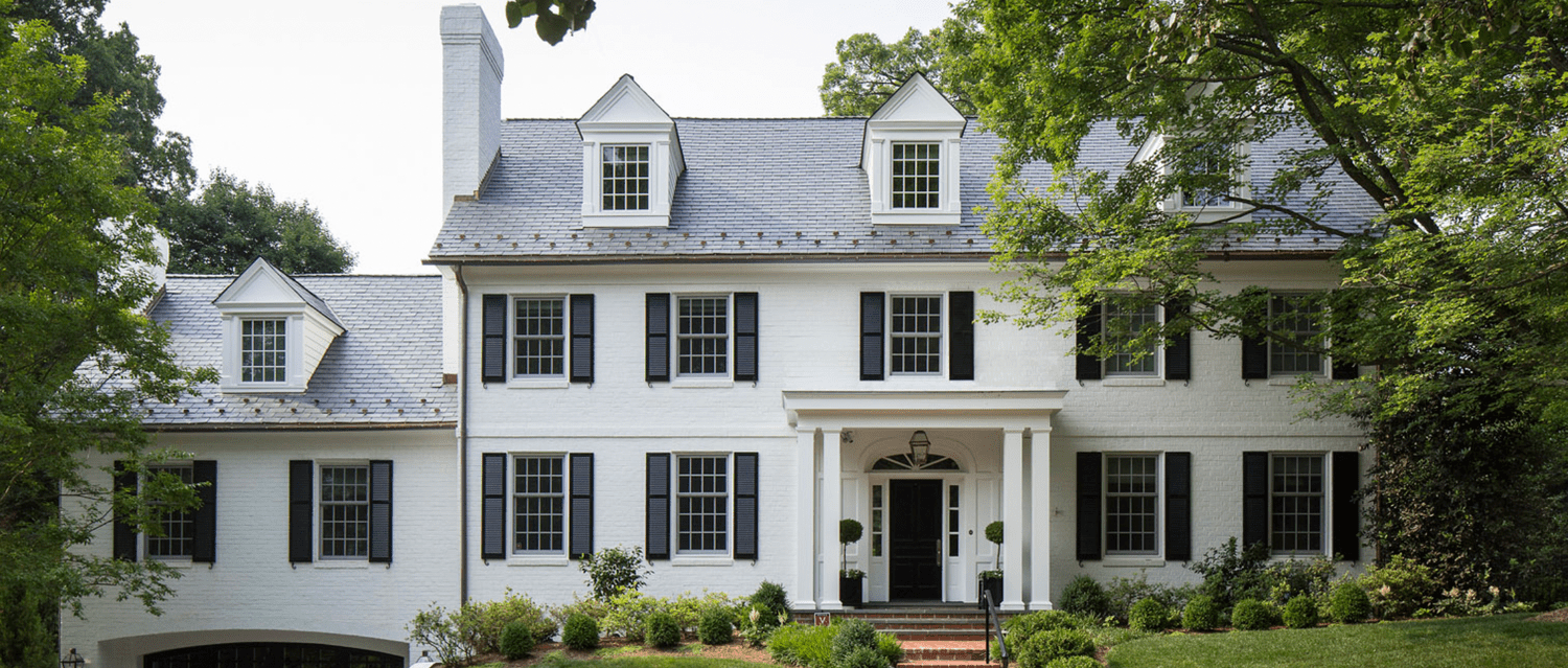 white house with brick red steps