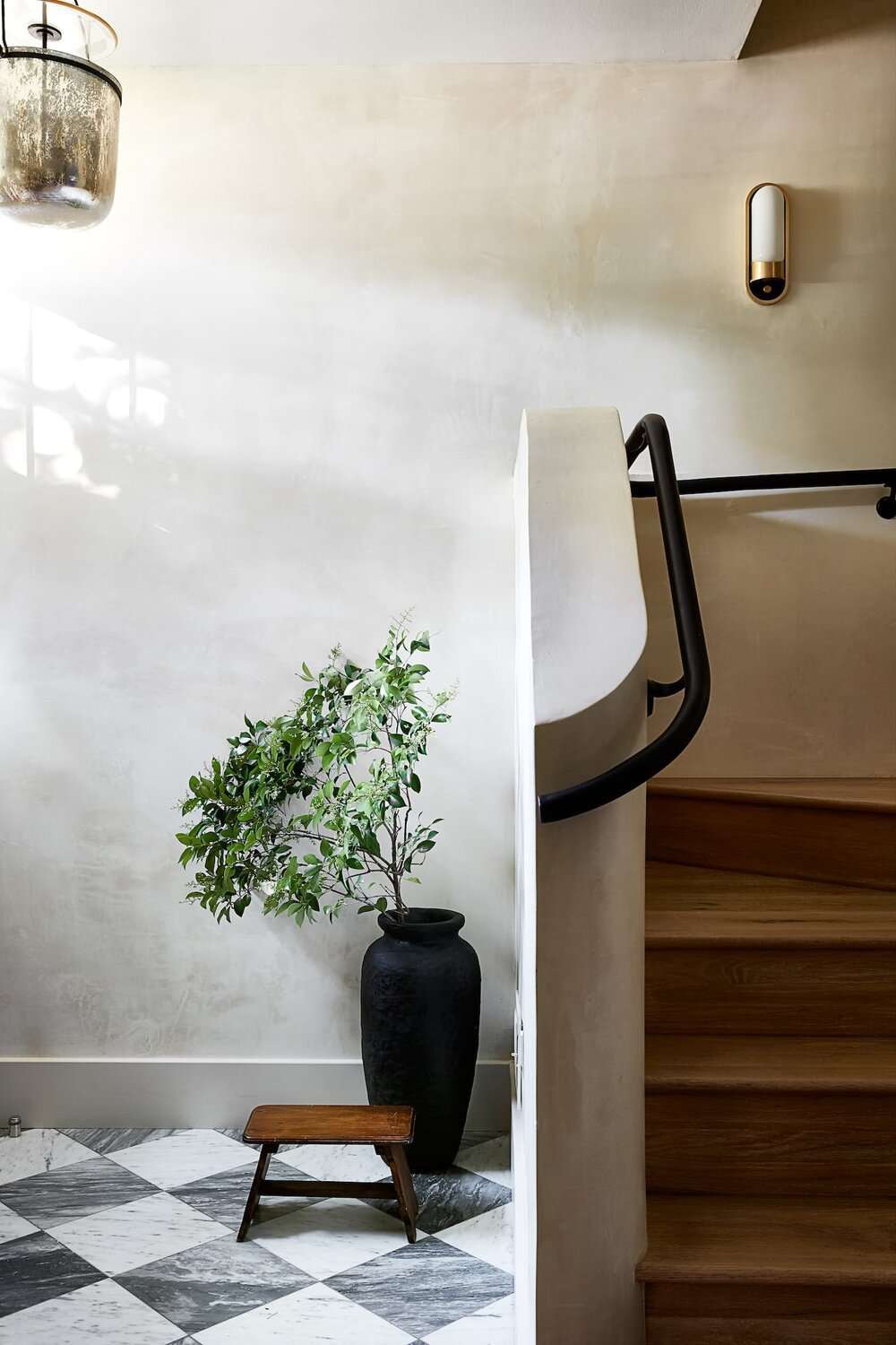 white plaster walls with black banister