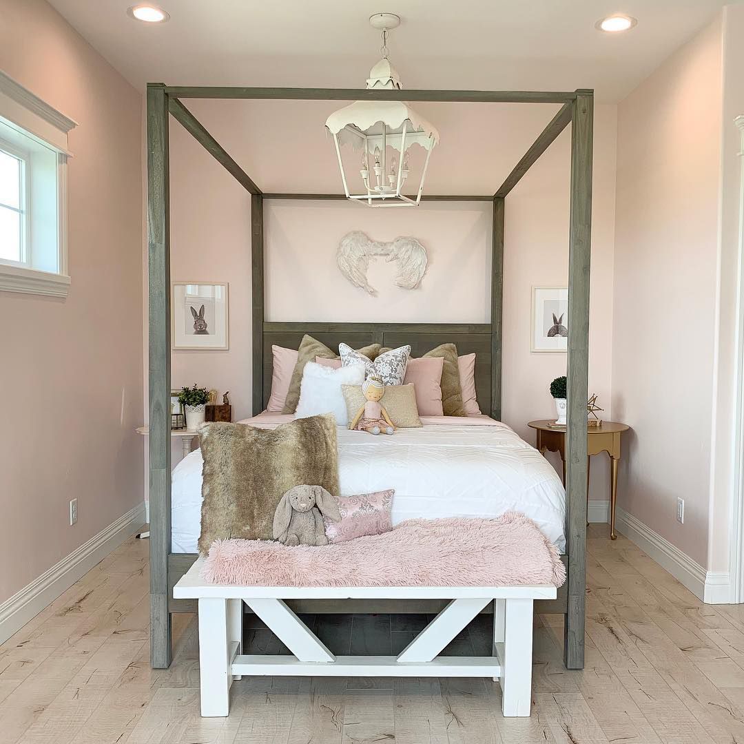 A girl's bedroom with light pink accents