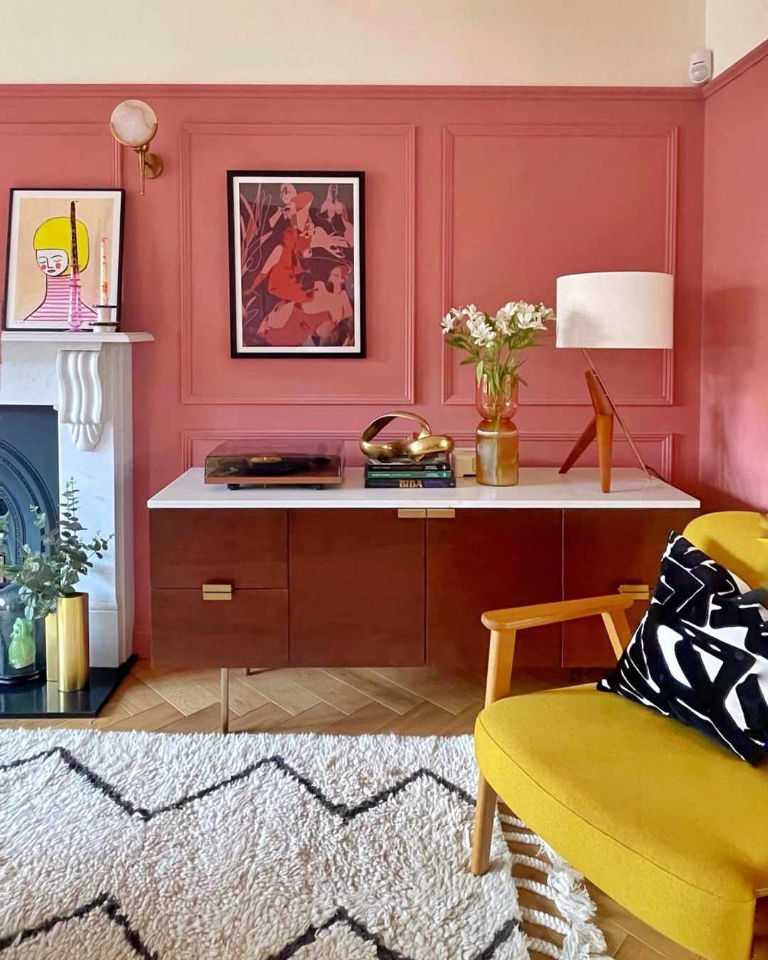 pink walls with yellow chair