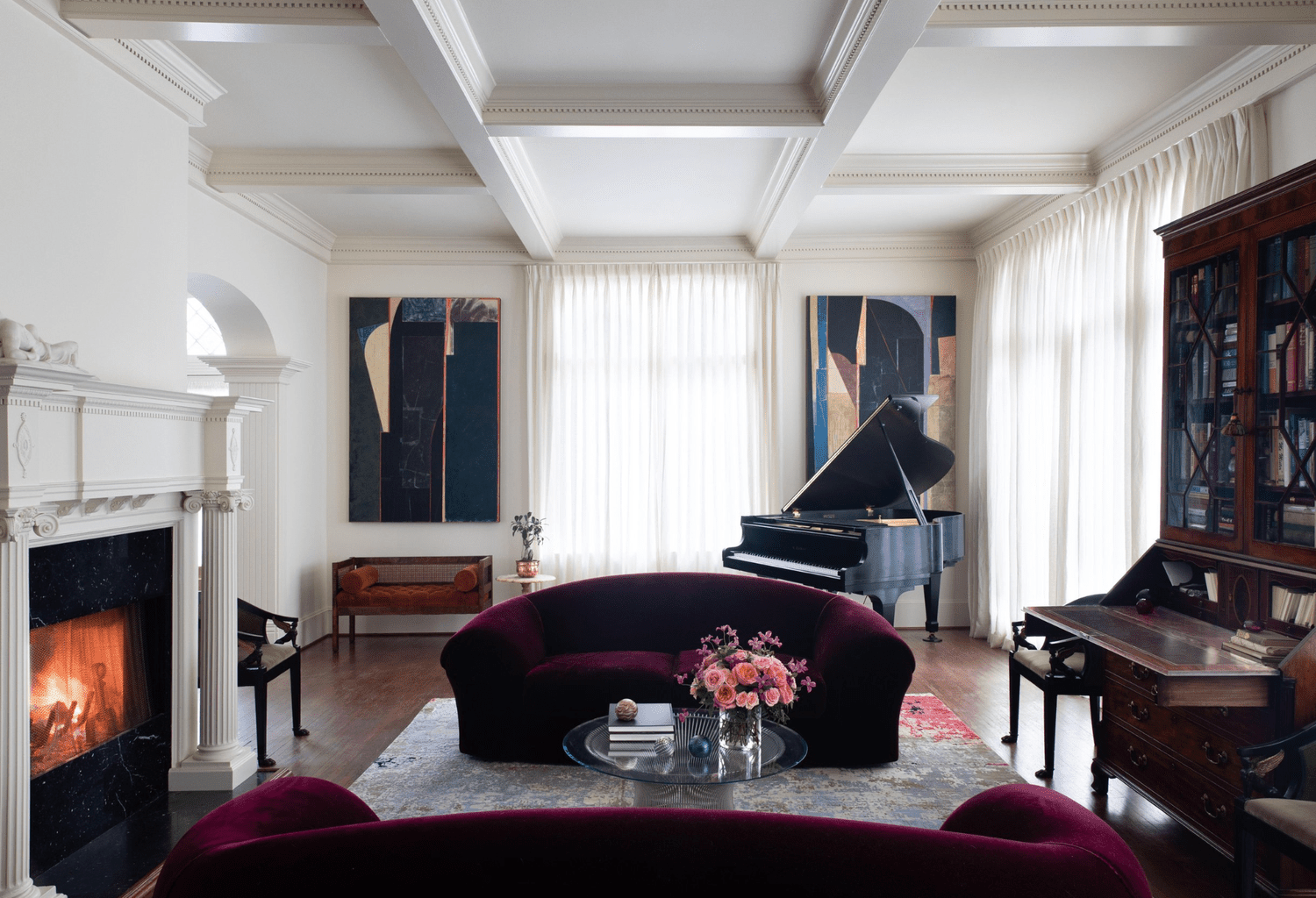 glam living room with burgundy sofas