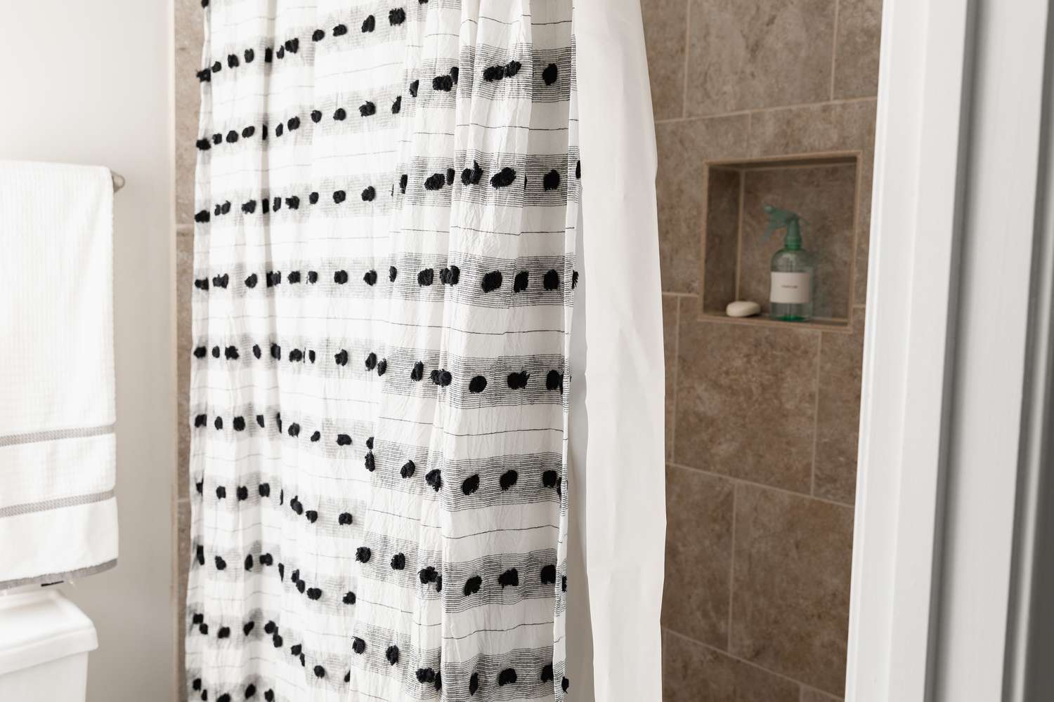 Using vinegar to clean soap scum on a shower curtain